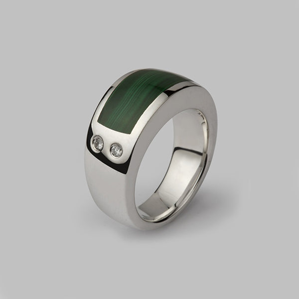 A sterling silver ring inlaid with malachite and set with two diamonds.